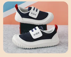 Close-up of breathable navy blue kids sneakers with white Velcro strap and rubber sole