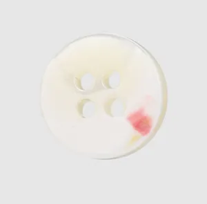 Detail view of high-end natural white trochus shell button with four holes for shirts