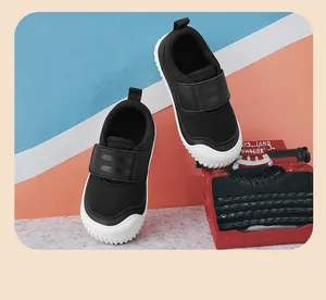 Detail of breathable black mesh kids' sneakers with convenient velcro strap closure