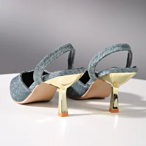 Detailed back view showing the gold metallic heel of sparkly blue slingback pumps