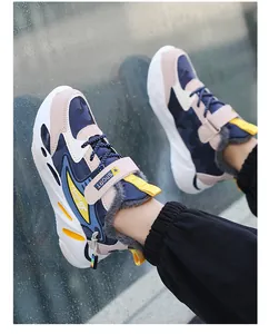 Detailed view of boys' winter warm fleece-lined sports shoes with blue and beige design.