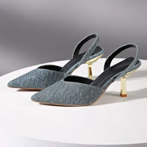 Detailed side view of elegant blue glitter pointed-toe slingback heels with gold kitten heels.