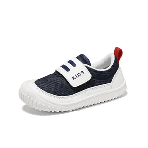 Breathable navy blue children's sneakers with white velcro strap and soft comfortable sole.