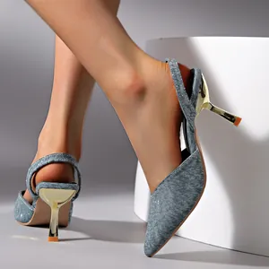 Detail shot of blue glitter pointed toe kitten heel slingback sandals worn by model.