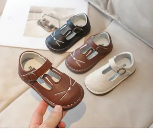 Close-up of cute cartoon girls' leather shoes with soft soles and velcro straps
