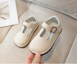 Close-up of the cute cartoon rabbit design on girls' soft-sole cream leather shoes.
