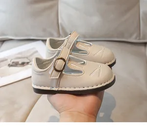 Close-up of cute bunny face embroidery on cream leather children's Mary Jane shoes