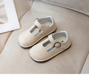 Detailed view of cream children's Mary Jane shoes with cute embroidered rabbit face design