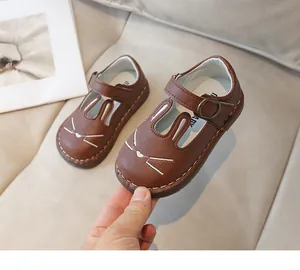 Detailed view of cute brown cartoon bunny girl's leather shoes with soft sole
