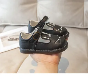 Detail view of cute black cartoon rabbit leather shoes for little girls with soft soles