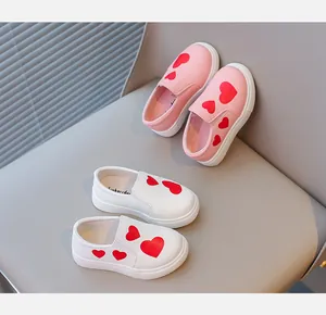 Adorable heart-patterned slip-on shoes for toddler girls in soft pink and white PU leather.