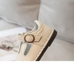 Detailed close-up view of cute cream baby girl leather shoe featuring a buckle strap