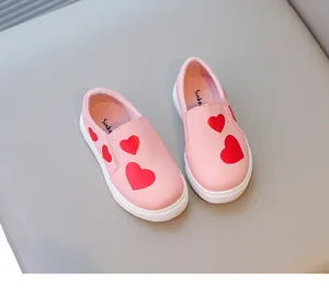 Pink slip-on shoes for girls featuring vibrant red heart patterns on soft white soles