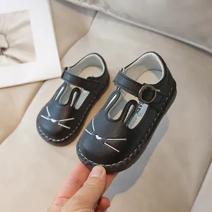 Adorable black leather Mary Jane shoes for girls featuring a cute cartoon bunny design