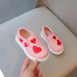 Stylish pink girl's slip-on leather shoes featuring cute red heart patterns and soft soles