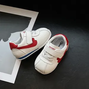 Soft sole toddler sneakers in white and red Cortez style for infants and babies