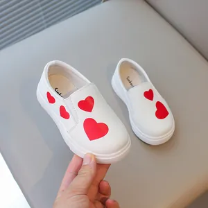 Stylish white slip-on loafers for girls featuring vibrant red heart patterns for spring