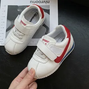 Toddler white walking shoes with red accents and soft sole, Cortez style design