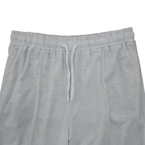 Primer plano de la cintura elástica con cordón ajustable en unos joggers grises