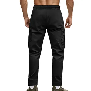 Rear view of men's black tactical cargo pants with elastic waist and side pockets.