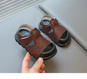 Close-up of brown toddler sandals showing durable faux leather and soft black sole