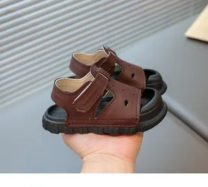 Detailed side view of children's brown leather closed-toe sandals with soft sole