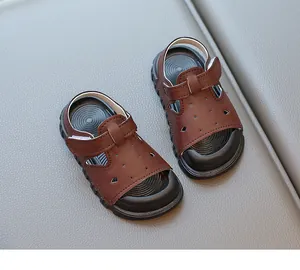 Detailed view of brown toddler sandals with soft soles and secure velcro straps
