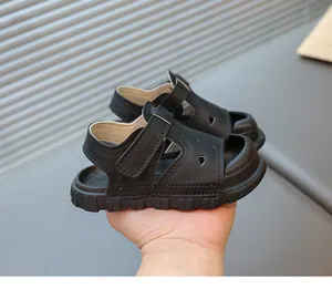 Detailed side view of black toddler closed-toe sandals with soft flexible soles