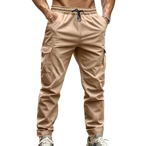 Detail of khaki men's tactical cargo pants with multiple pockets and drawstring waist.