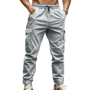 Detailed view of light grey tactical cargo pants with elastic drawstring waist and side flap pockets