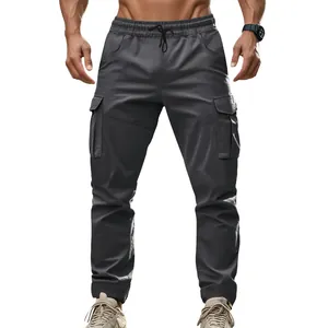 Front view of men's dark grey tactical cargo pants with elastic waist and side pockets
