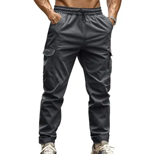 Detail view of men's charcoal tactical cargo joggers with side pockets on white background