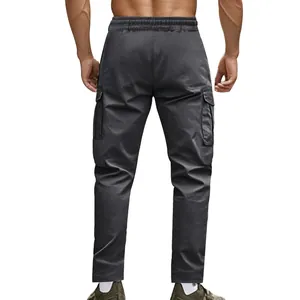 Back view of men's tactical outdoor cargo pants in dark grey featuring side pockets.