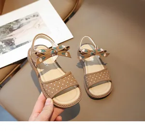 Detalle de las sandalias de princesa con lunares marrones y lazo para niñas pequeñas