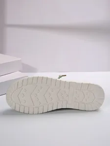 Detailed close-up of the non-slip white rubber outsole for women's flat casual shoes