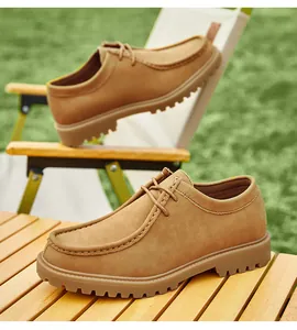 Detailed side view of classic tan suede Wallabee-style lace-up derby shoes for men.