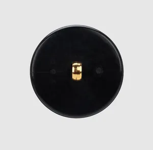 Detailed back view of a high-end black circular button with a metallic gold shank