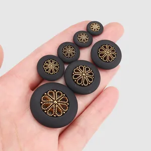 Premium black plant fiber nylon buttons with intricate gold filigree flower center