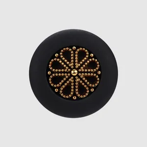 High-end elegant black nylon button with a detailed golden beaded flower pattern insert