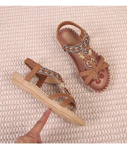 Detailed side view of Bohemian brown sandals with beads, butterfly and heart ornaments