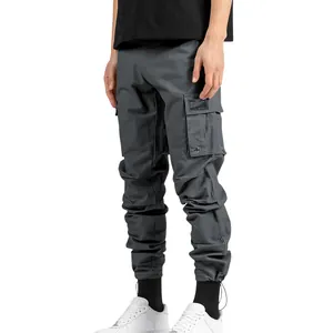 Detail side view of men's grey multi-pocket cargo pants with stylish cuffed ankles.