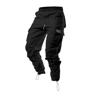 Close-up detail of black men's cargo pants featuring elastic waistband and functional multi-pockets