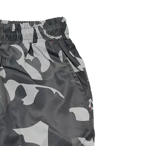 Detailed macro view of elastic waistband and pocket on men's camouflage cargo pants