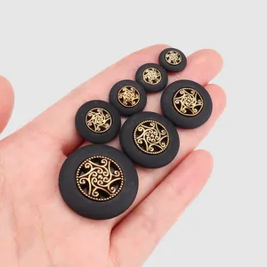 High-end matte black plant fiber buttons with gold ornate center for luxury garments