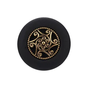 High-end vintage round button in black and gold with intricate filigree center design