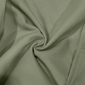 Close-up of olive green twill fabric texture on casual cargo trousers