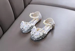 Detailed view of silver glitter girls princess shoes with butterfly and pearl accents