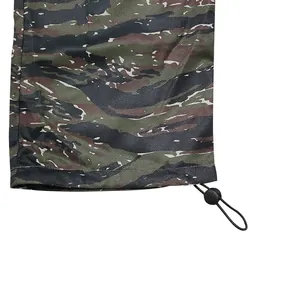 Close-up view of the adjustable drawstring cuff on tiger stripe camouflage cargo pants