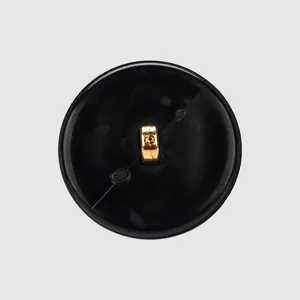High-end black plant fiber nylon button with a golden shank for elegant sewing projects.