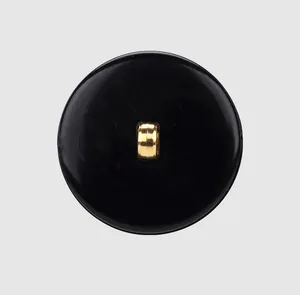 Macro view of high-end black nylon shank button with gold metal loop